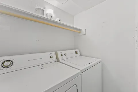 a view of a wooden balcony and trees