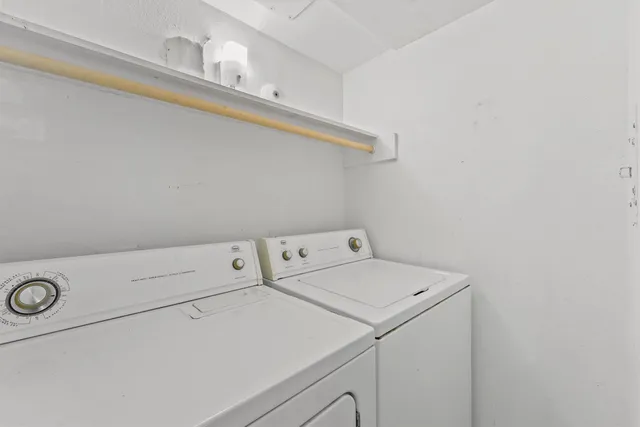 a view of a wooden balcony and trees