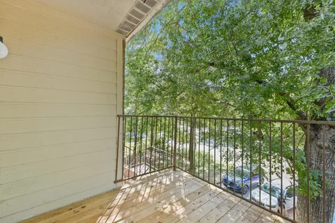 a view of a patio with a table and chairs under an umbrella