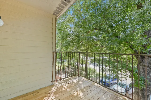 a view of a patio with a table and chairs under an umbrella