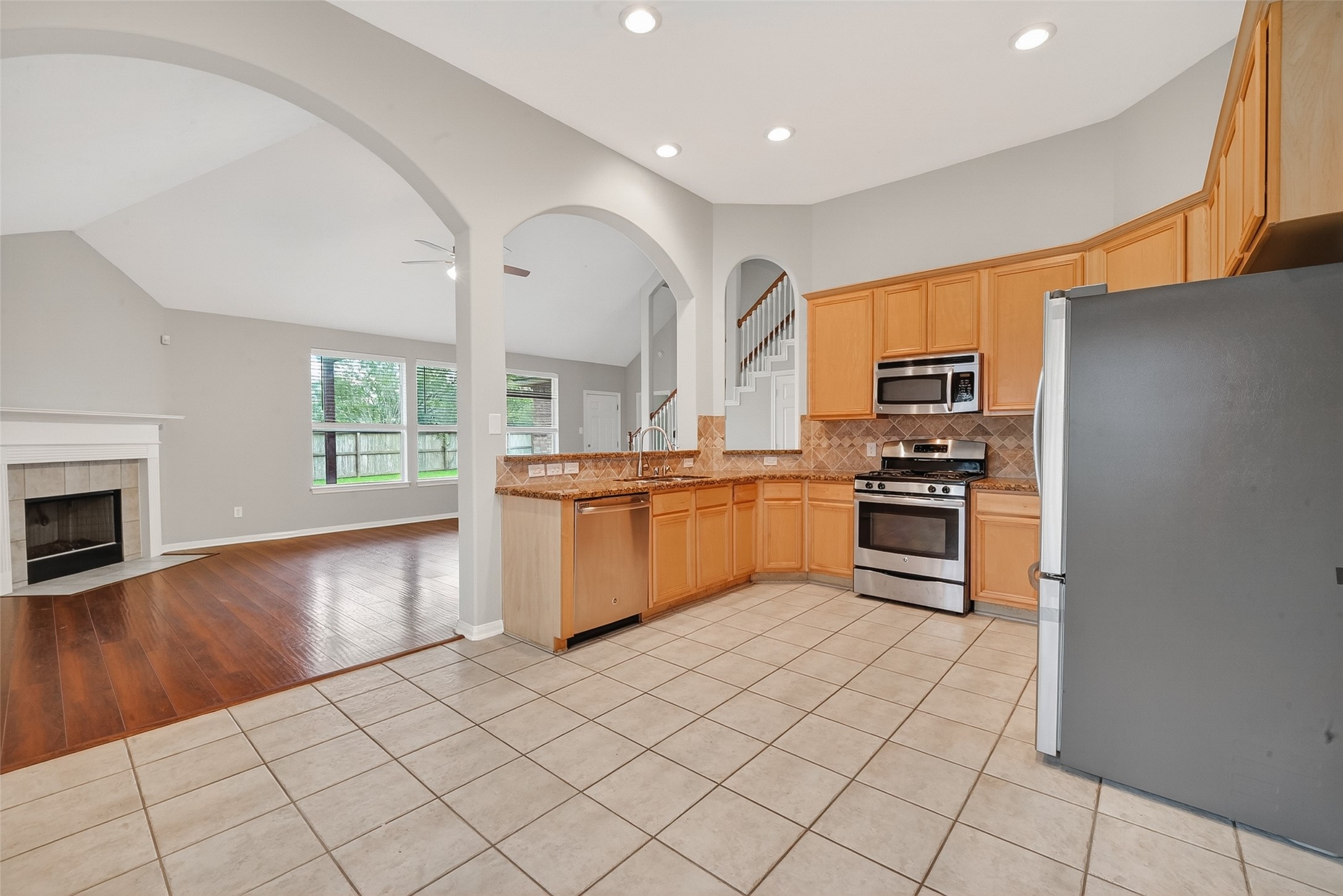 14308 Rocky Briar Lane Rosharon, TX 77583 - Photo 10 of 46 a kitchen with stainless steel appliances a refrigerator and a stove top oven