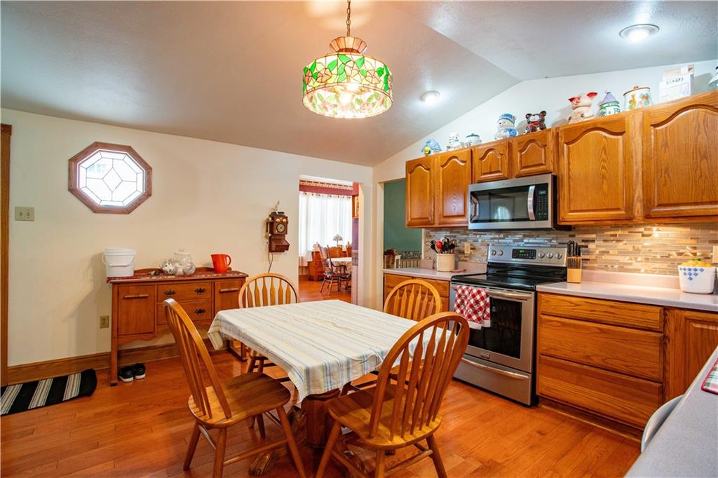 166 Pennsylvania Avenue Rochester, PA 15074 - Photo 10 of 30 a view of a dining room with furniture a kitchen and chandelier