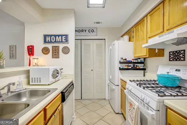 a kitchen with stainless steel appliances granite countertop a sink and a stove