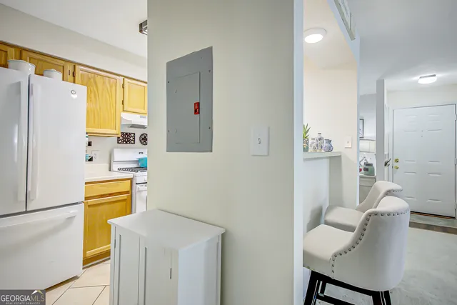 a kitchen with a refrigerator and a table