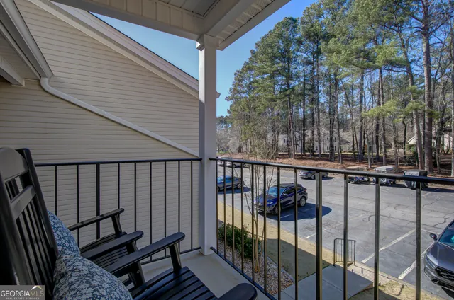 a view of a balcony with wooden floor and fence
