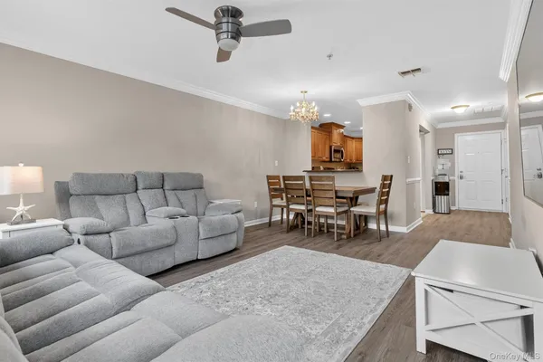a living room with furniture and kitchen view
