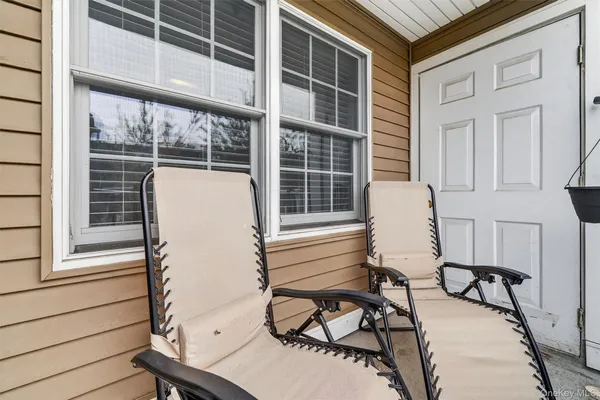 a view of a chair and table in the balcony