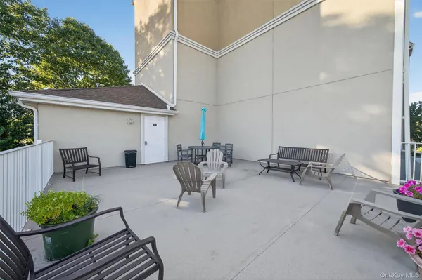 a view of a patio with couches chairs and potted plants