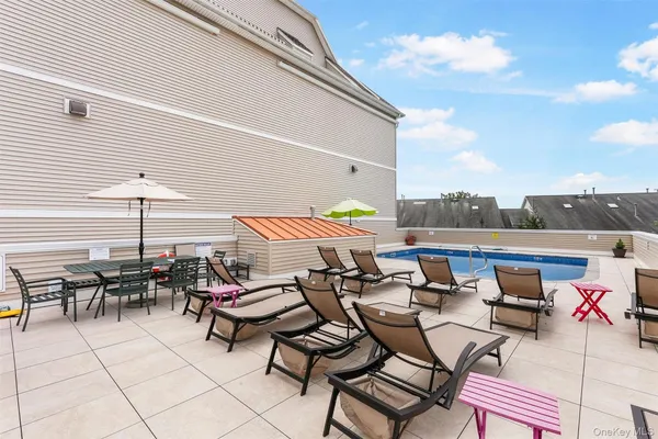 a view of a patio with couple of chairs