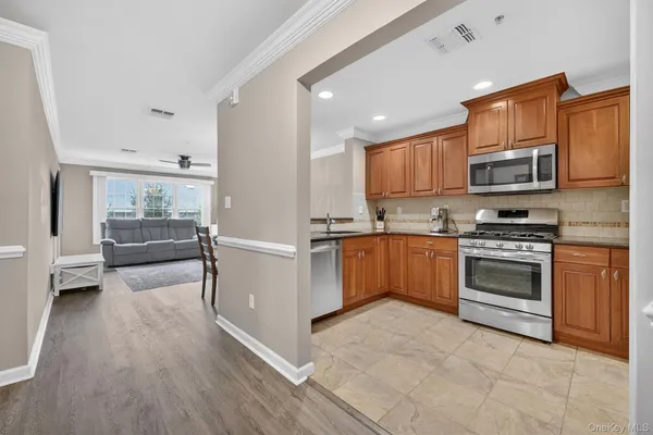 a kitchen with granite countertop a stove top oven and cabinets