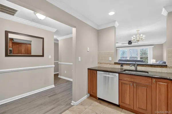 a bathroom with a granite countertop sink mirror and cabinets