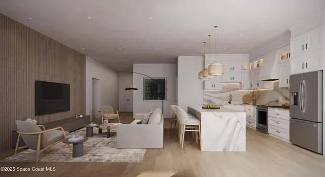 a living room with furniture a flat screen tv and kitchen view