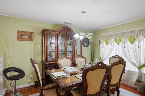 a view of a dining room with furniture and chandelier