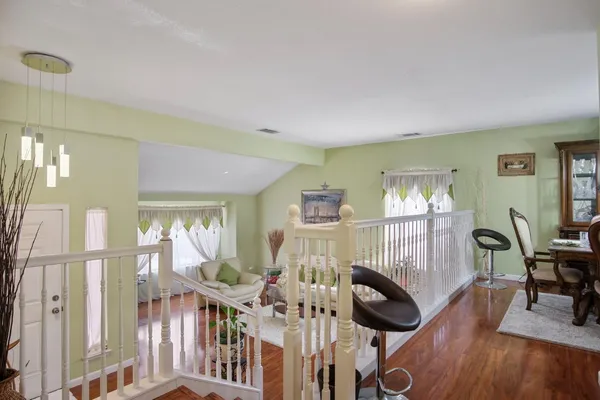 a view of a livingroom with furniture wooden floor and windows