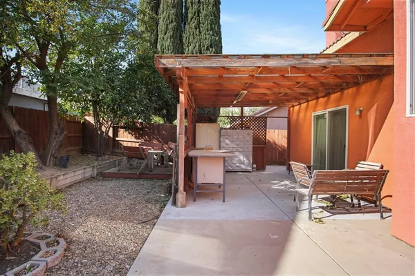 a backyard of a house with table and chairs