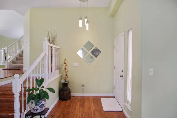 a view of entryway and hall with wooden floor