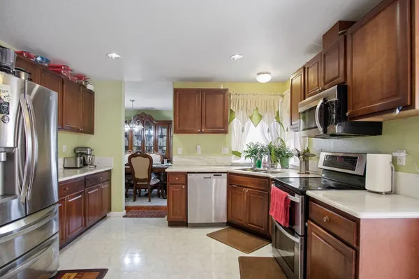 a kitchen with a sink refrigerator and cabinets
