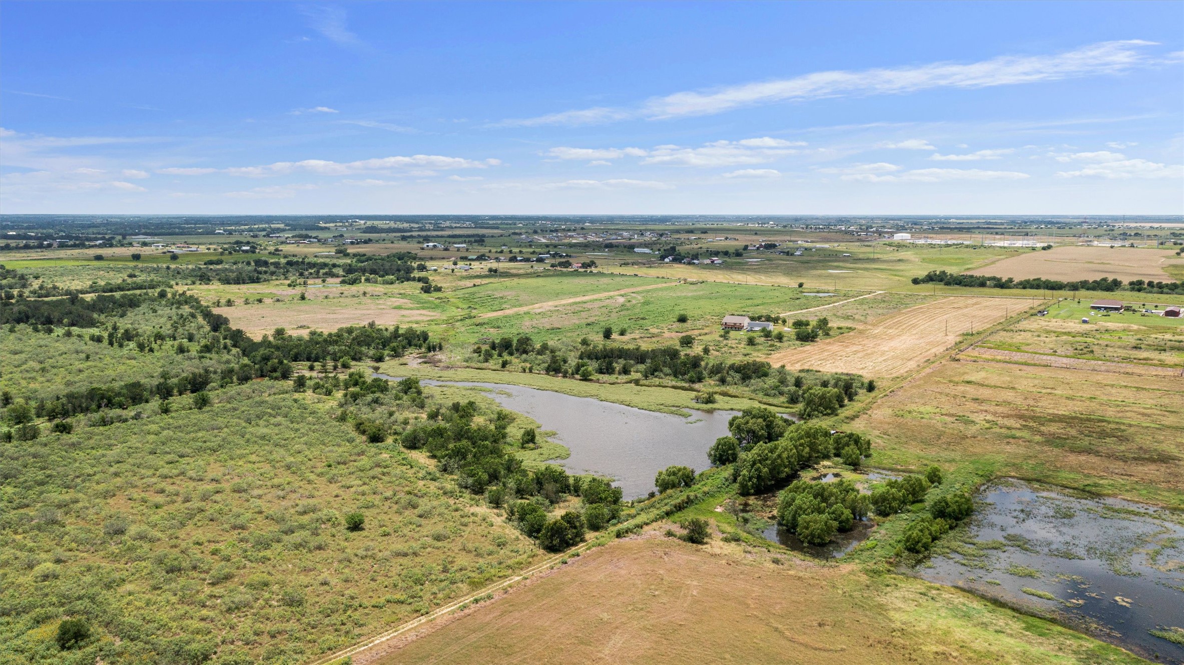 3315 County Road 463 Elgin, TX 78621 - Photo 28 of 32 Vast, open terrain offers a serene rural landscape with natural water features and distant community views.