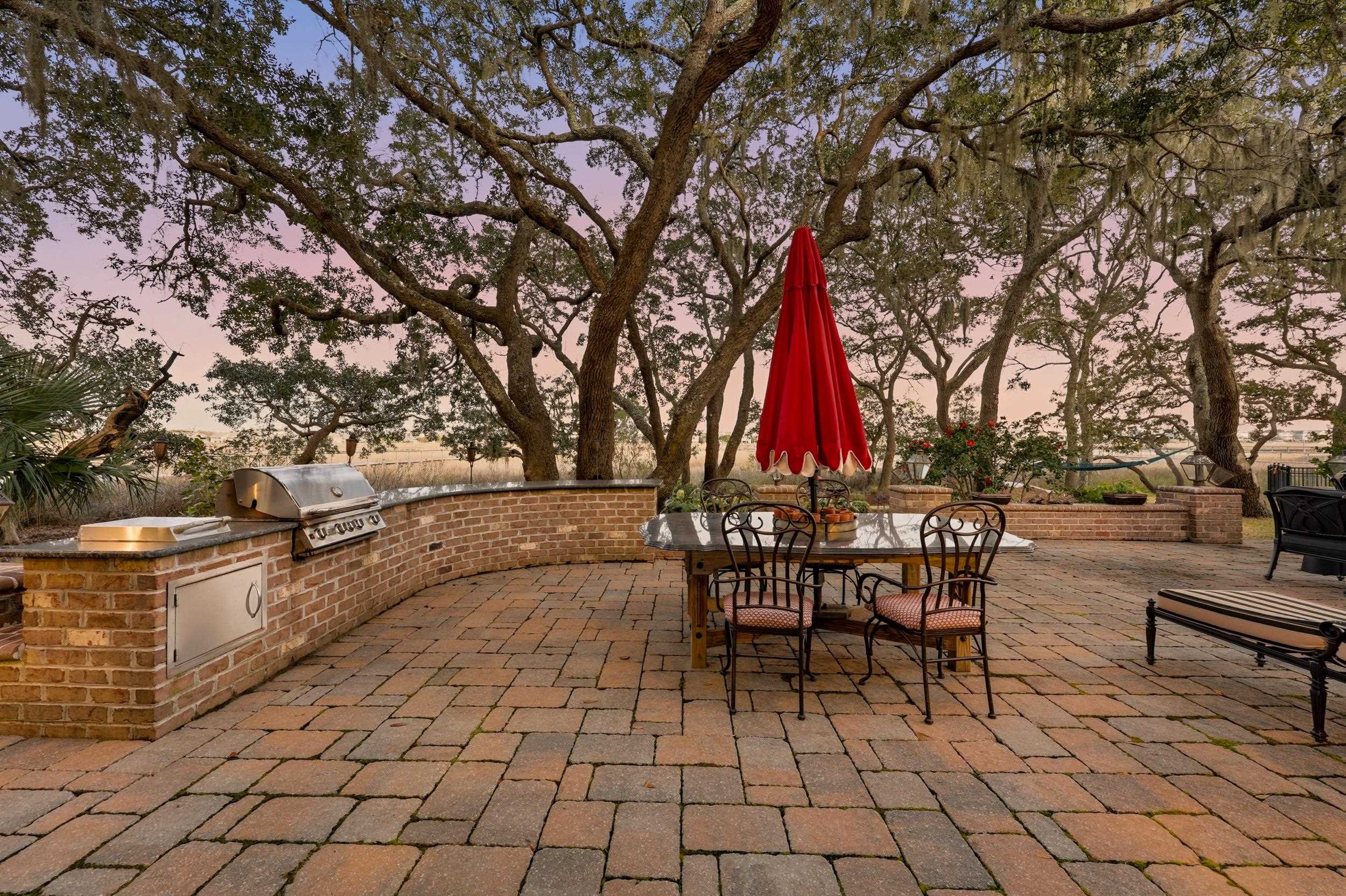 46 High Hammock Way Pawleys Island, SC 29585 - Photo 30 of 40 Patio terrace at dusk featuring a patio, outdoor dining area, and an outdoor kitchen