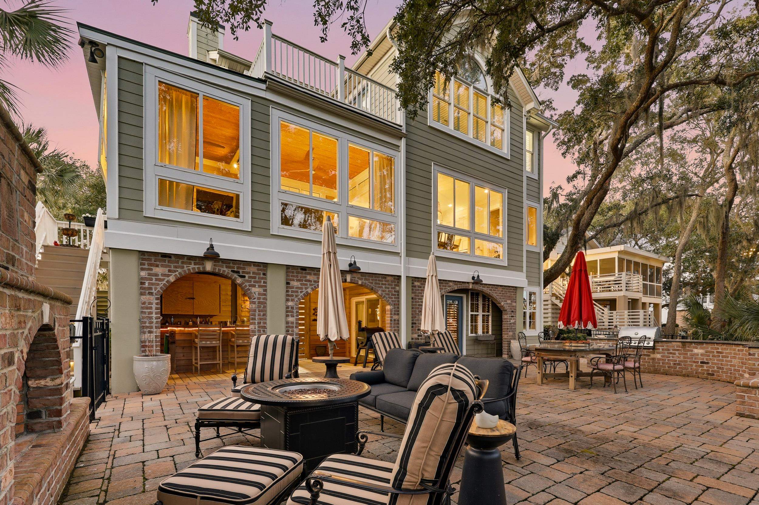 46 High Hammock Way Pawleys Island, SC 29585 - Photo 31 of 40 Rear view of house with outdoor dining area, a patio area, brick siding, an outdoor living space with a fire pit, and a chimney