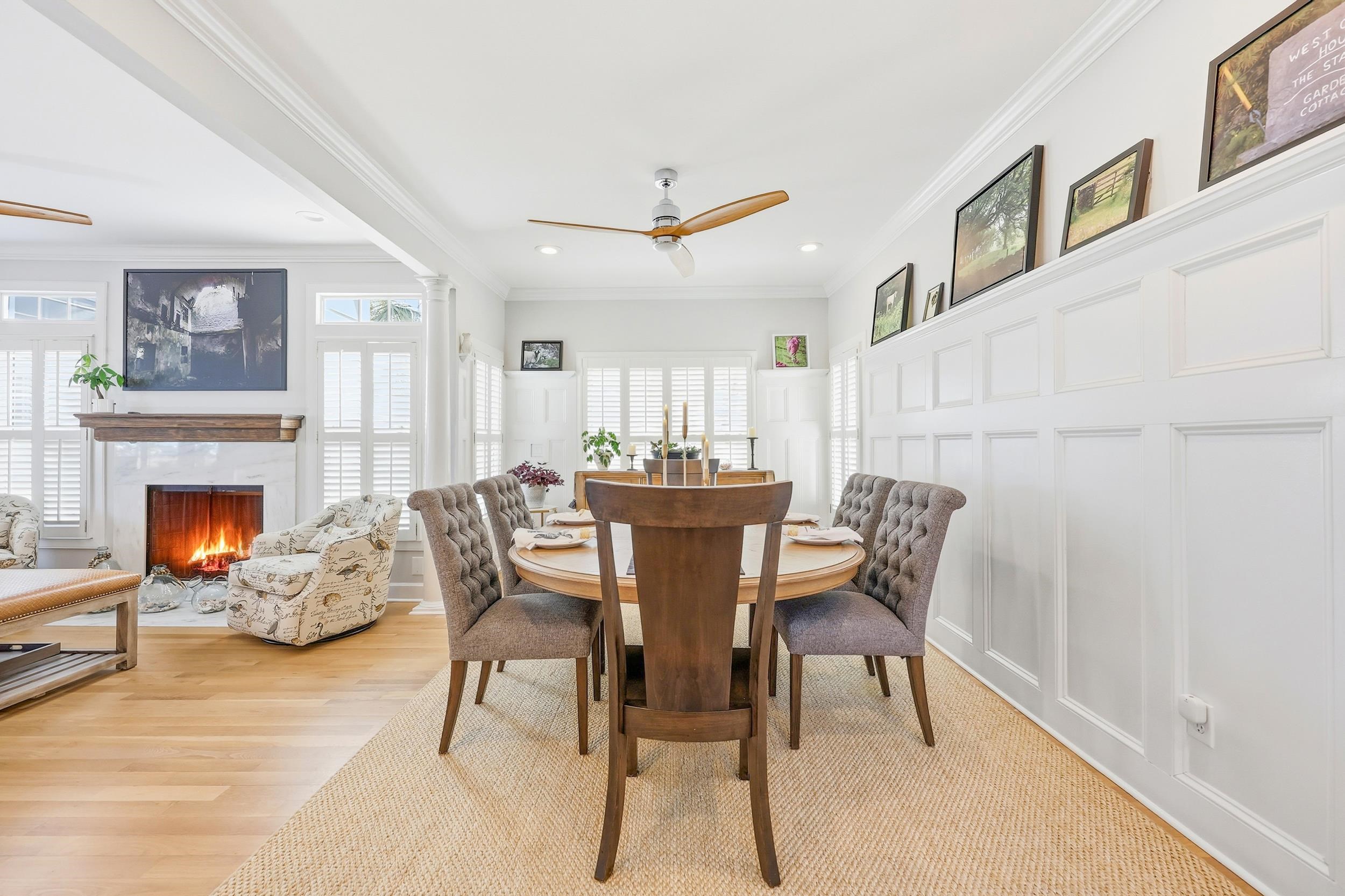 46 High Hammock Way Pawleys Island, SC 29585 - Photo 7 of 40 Dining room with ceiling fan, a decorative wall, crown molding, a fireplace, and recessed lighting