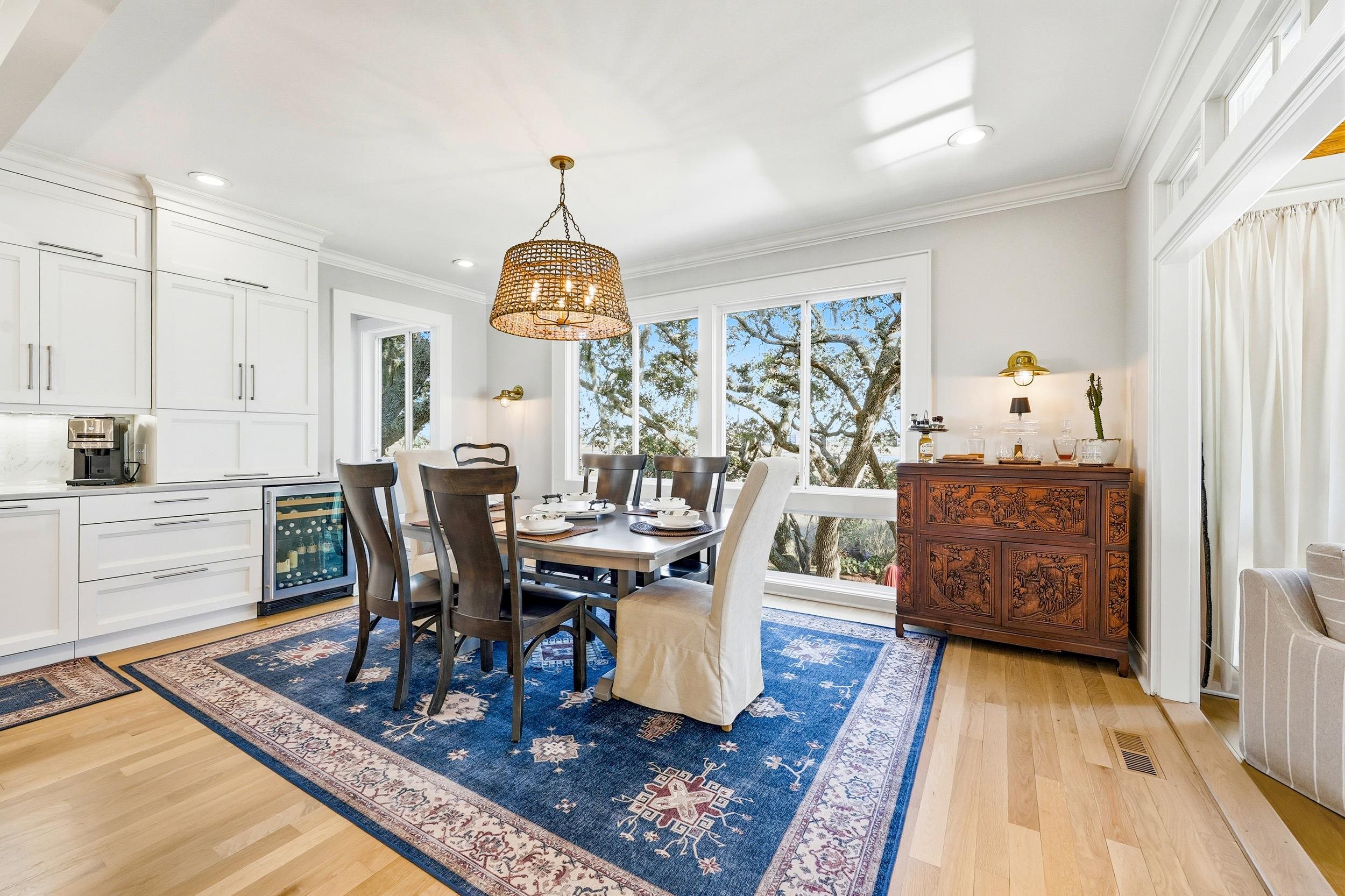 46 High Hammock Way Pawleys Island, SC 29585 - Photo 8 of 40 Dining room with light wood-type flooring, a chandelier, wine cooler, ornamental molding, and recessed lighting