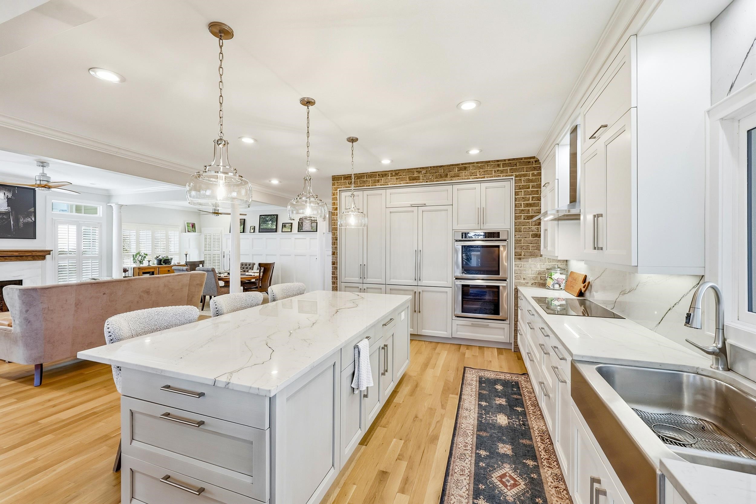 46 High Hammock Way Pawleys Island, SC 29585 - Photo 40 of 40 Kitchen featuring open floor plan, hanging light fixtures, light stone counters, a breakfast bar, and light wood finished floors
