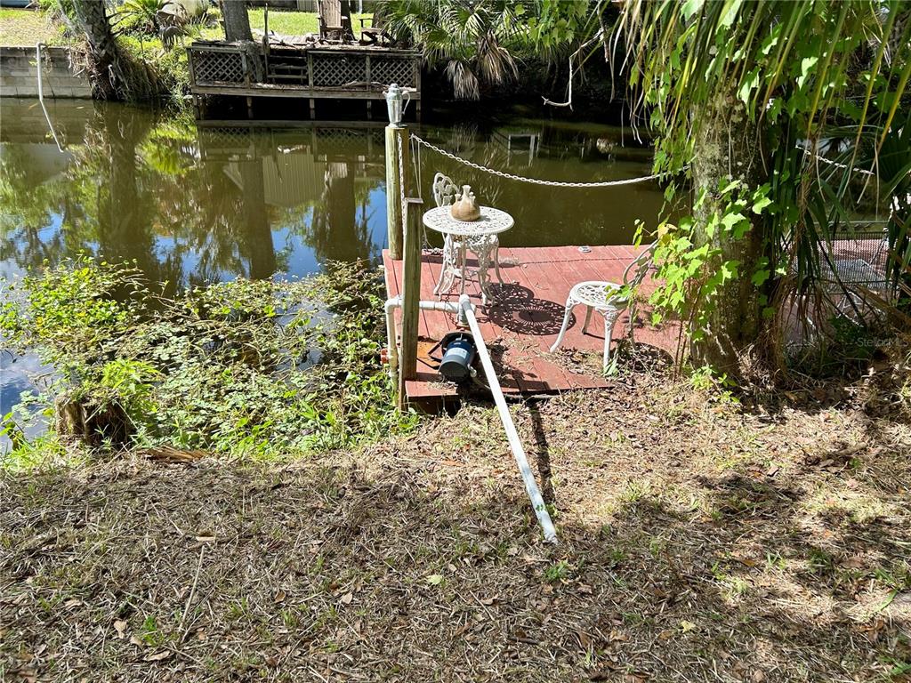 25646 Bass Road Astor, FL 32102 - Photo 10 of 48 a view of a lake with a deck