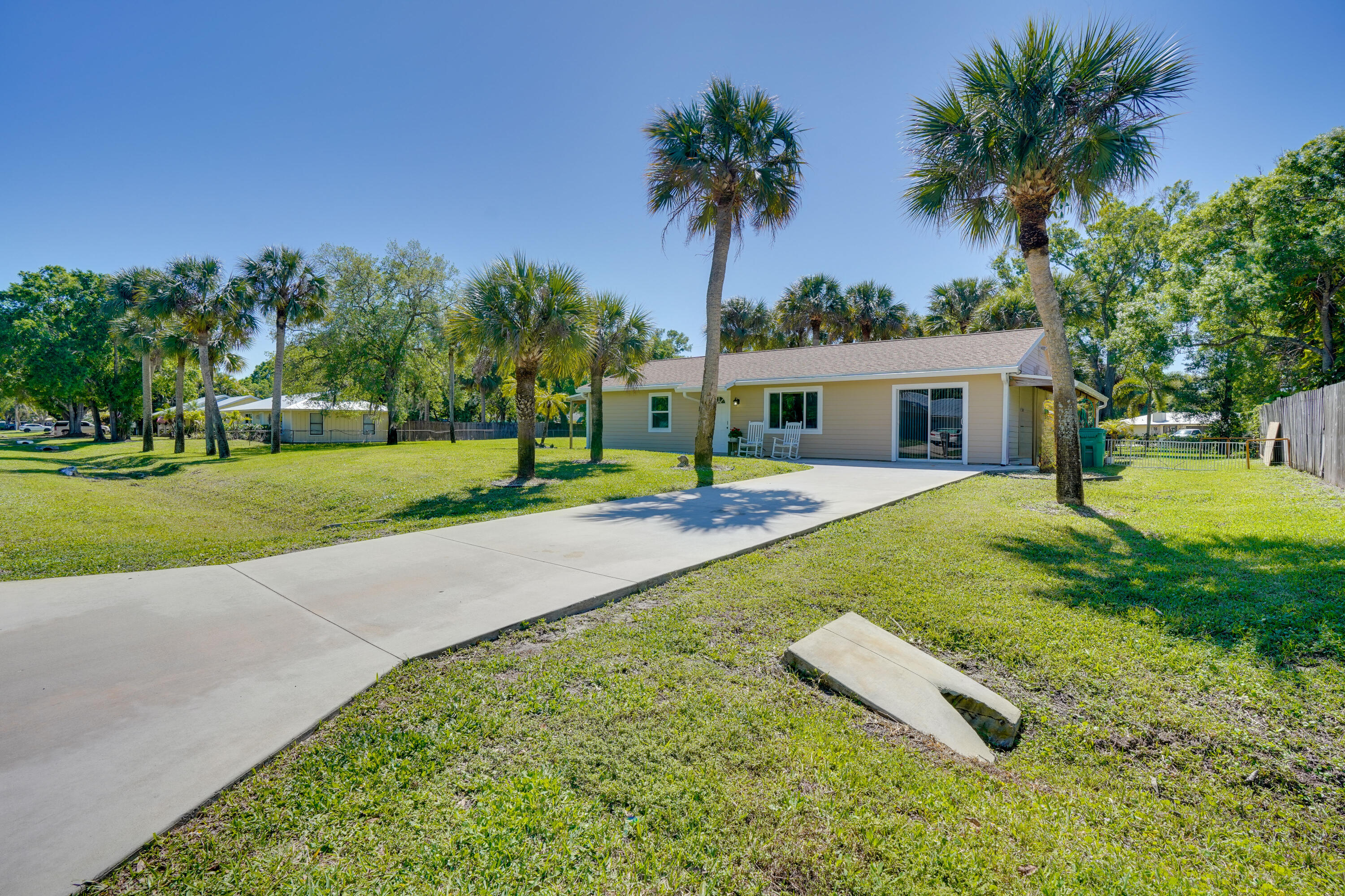 7601 Donlon Road Fort Pierce, FL 34951 - Photo 1 of 32 a view of a house with a yard and palm tree