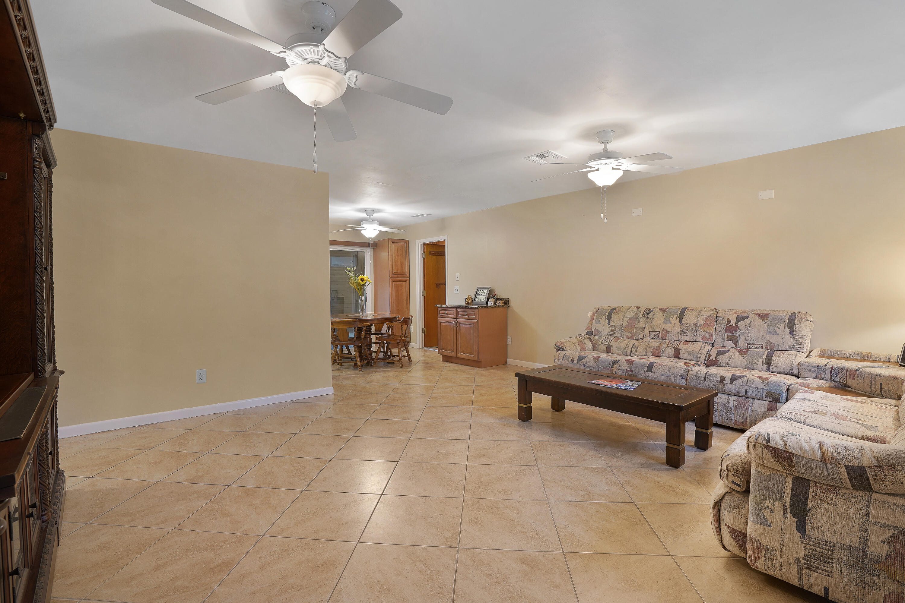 7601 Donlon Road Fort Pierce, FL 34951 - Photo 11 of 32 a view of a livingroom with furniture and a ceiling fan