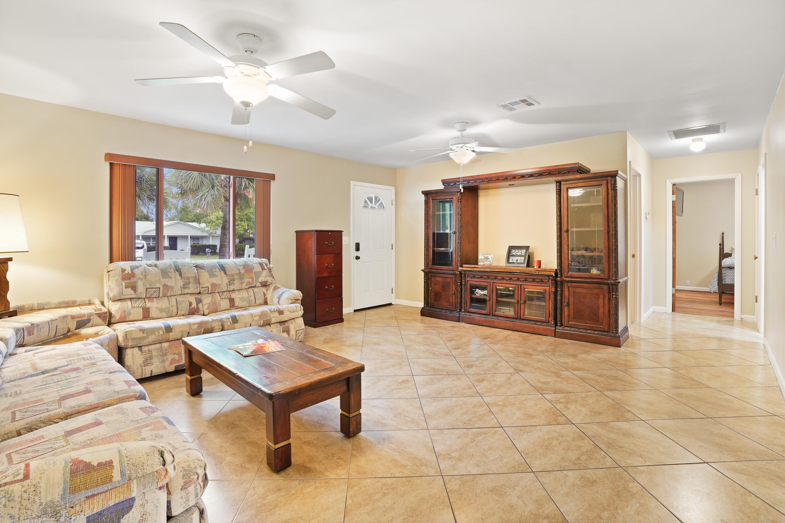 7601 Donlon Road Fort Pierce, FL 34951 - Photo 12 of 32 a living room with furniture and a large window