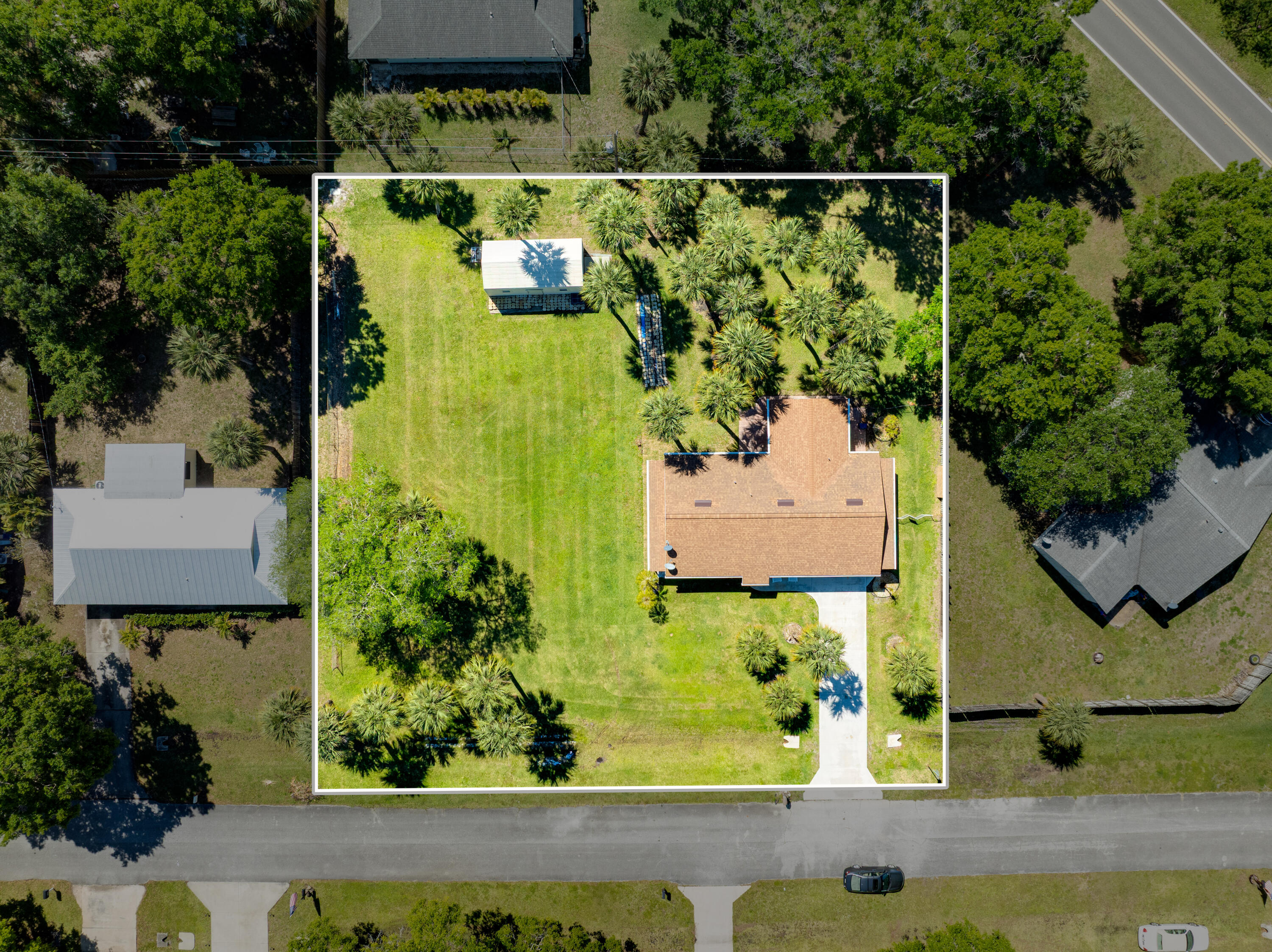 7601 Donlon Road Fort Pierce, FL 34951 - Photo 3 of 32 an aerial view of a house with a yard and lake view