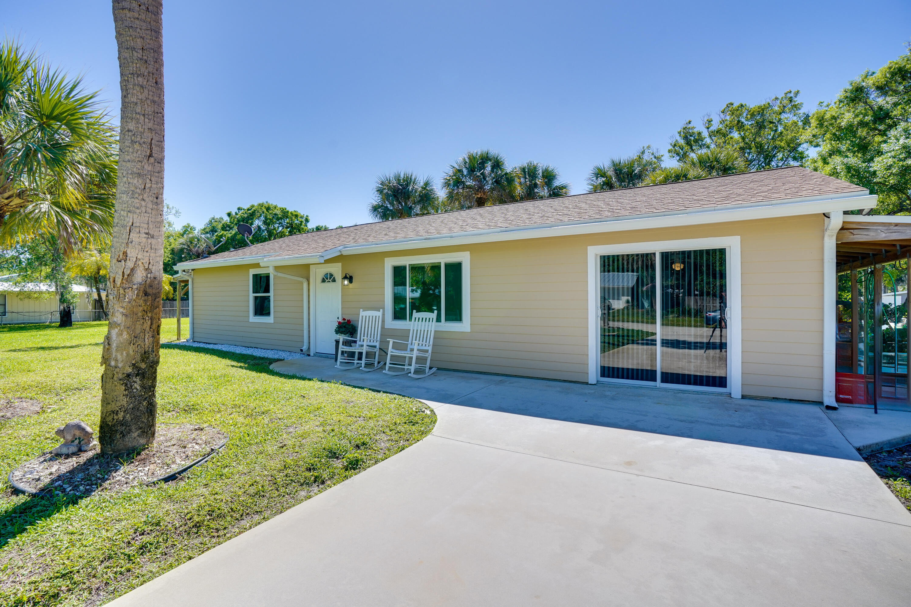 7601 Donlon Road Fort Pierce, FL 34951 - Photo 5 of 32 front view of a house with a patio