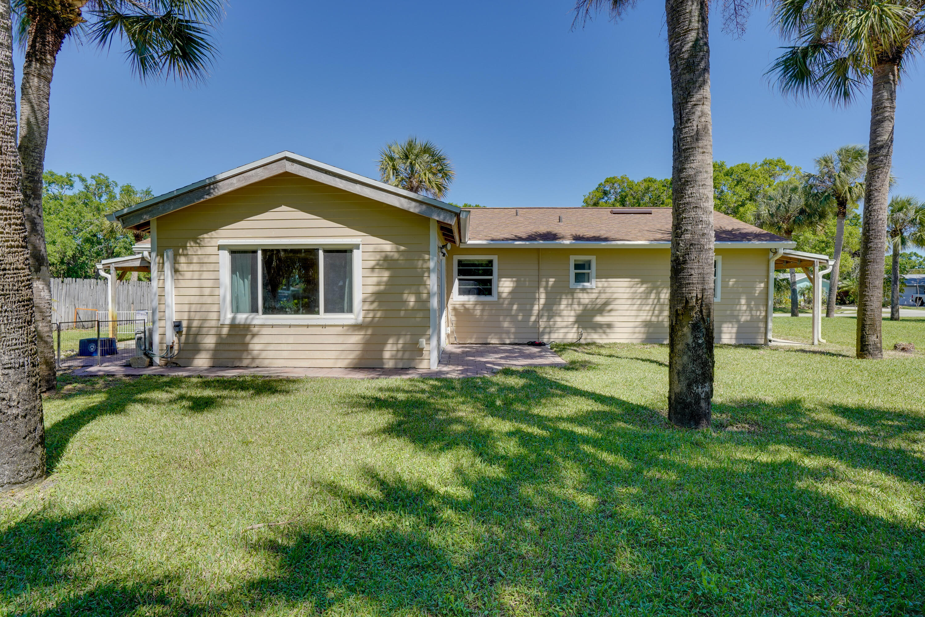 7601 Donlon Road Fort Pierce, FL 34951 - Photo 9 of 32 a front view of a house with garden