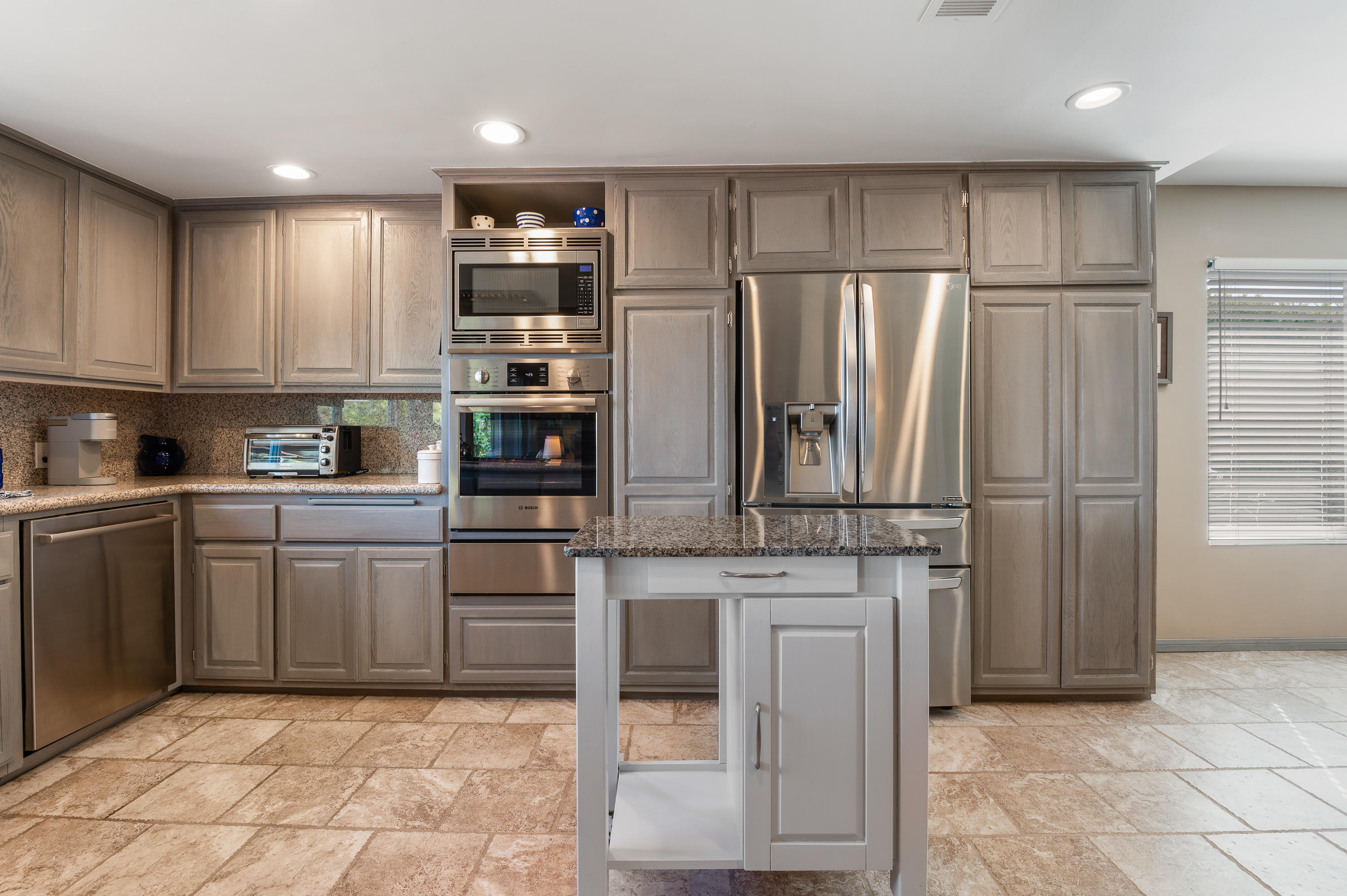 3894 San Augustine Drive Glendale, CA 91206 - Photo 11 of 51 a kitchen with stainless steel appliances granite countertop a refrigerator and a stove top oven