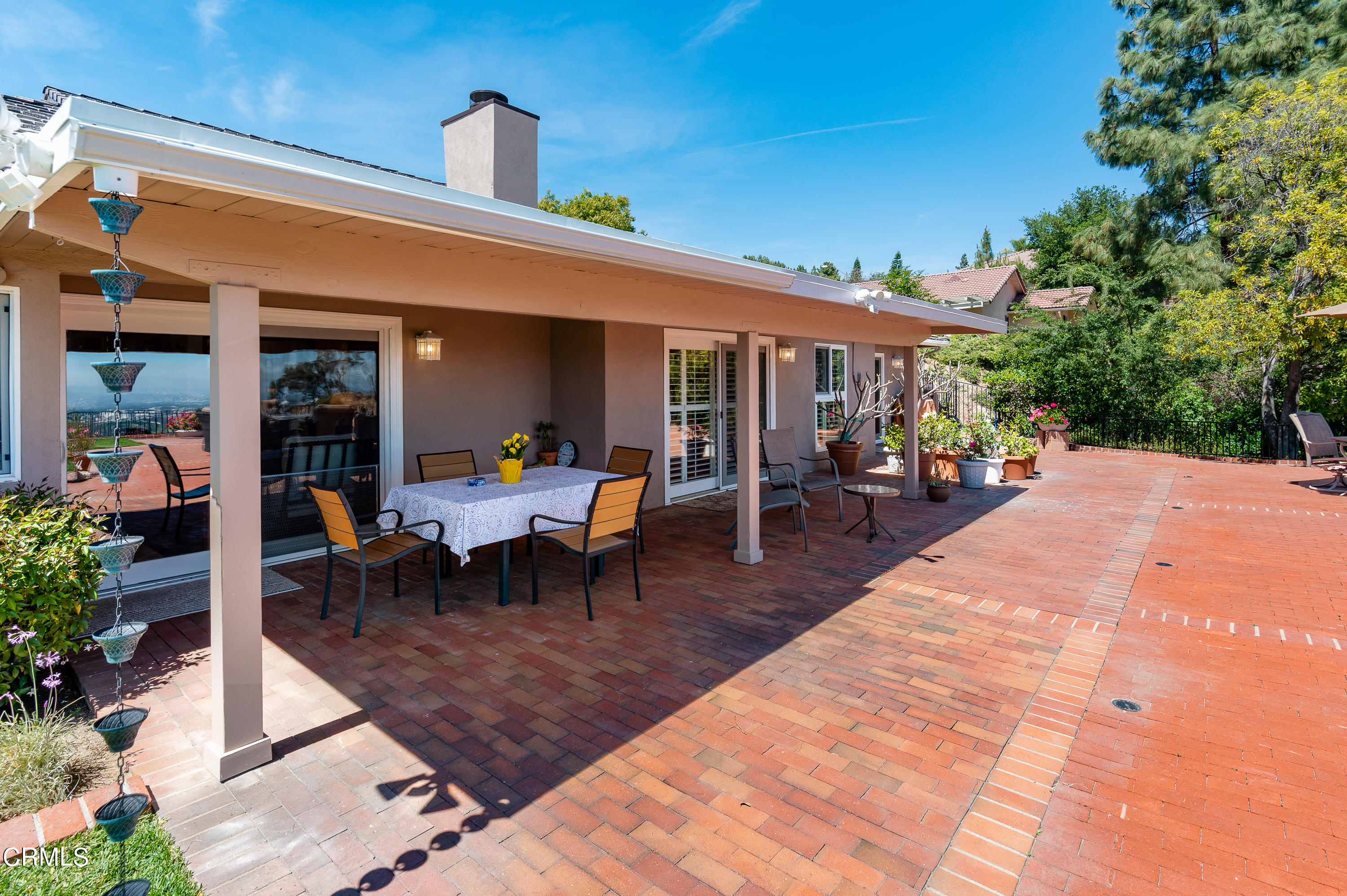 3894 San Augustine Drive Glendale, CA 91206 - Photo 30 of 51 a view of a patio with table and chairs potted plants and a palm tree