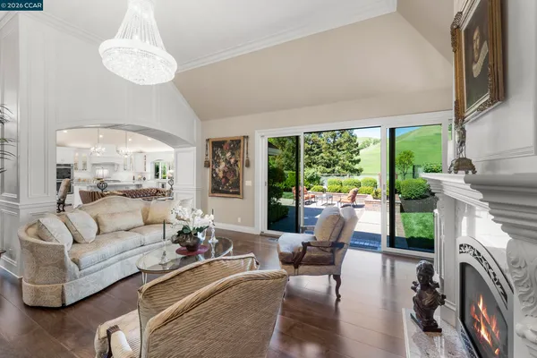 a living room with furniture a large window and a fireplace