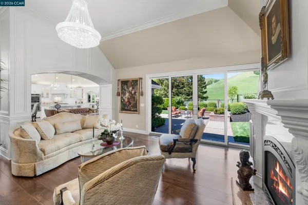 a living room with furniture a fireplace and a large window