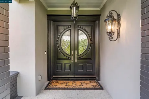 a view of a entryway door with wooden door