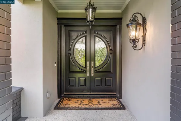 a view of a entryway door with wooden door