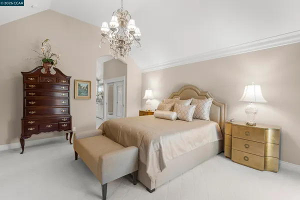 a bedroom with a bed and a chair