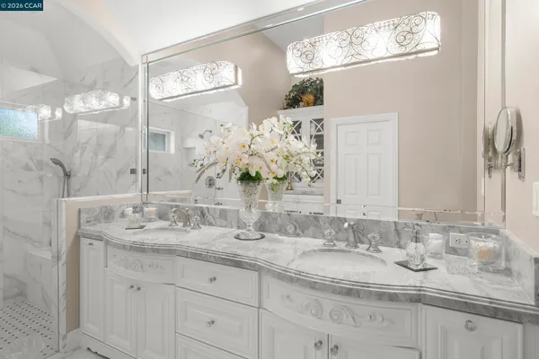a bathroom with double sink and a mirror