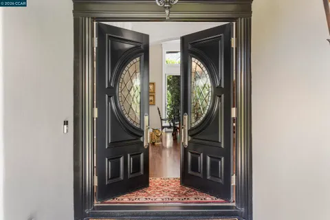 a view of a hallway with wooden floor and a hallway
