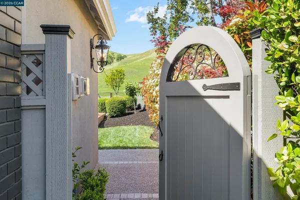 an outdoor sitting area with furniture and garden