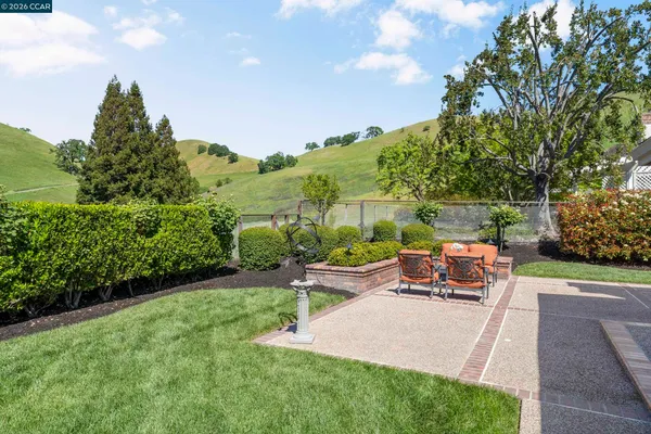 a view of a house with swimming pool and sitting area