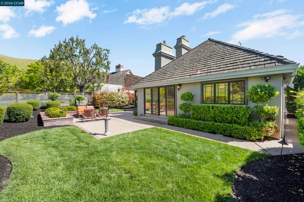 a aerial view of a house with a garden and lake view