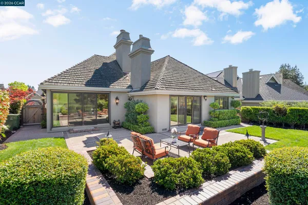an aerial view of multiple houses with a swimming pool