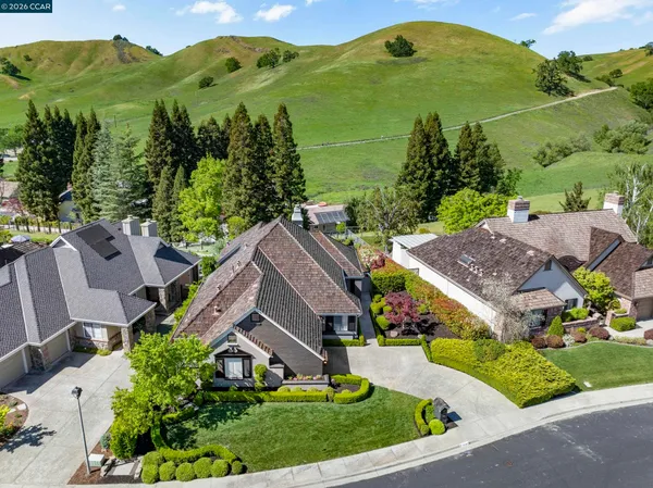 a view of a chairs and table in the back yard