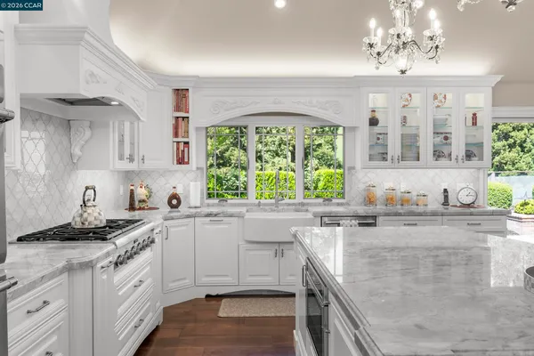a kitchen with stainless steel appliances granite countertop a sink stove and cabinets