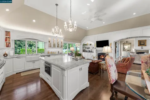 a kitchen with stainless steel appliances kitchen island a large island in the center and wooden floor
